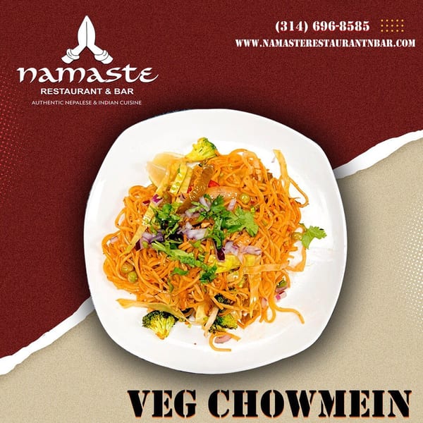 A plate of Namaste Curry Lounge's Veg Chowmein, featuring noodles, broccoli, and fresh herbs.